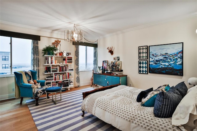 bedroom featuring wood-type flooring, a chandelier, and crown molding