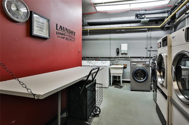 washroom with washer and clothes dryer and sink