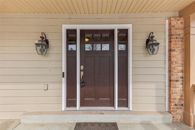 entrance to property with brick siding