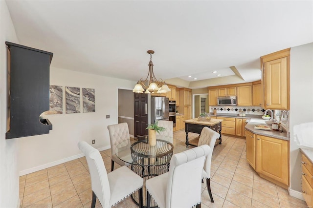 dining space with light tile patterned floors, a notable chandelier, recessed lighting, baseboards, and a tray ceiling