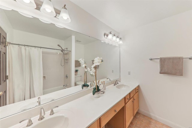 full bath featuring double vanity, toilet, tile patterned floors, shower / bathtub combination with curtain, and a sink