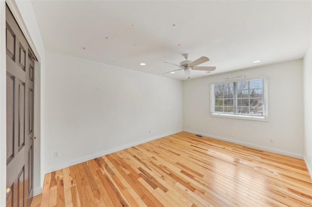 empty room with recessed lighting, visible vents, a ceiling fan, baseboards, and light wood-type flooring