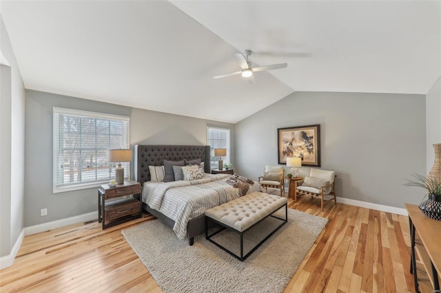 bedroom featuring light wood-style floors, vaulted ceiling, baseboards, and a ceiling fan