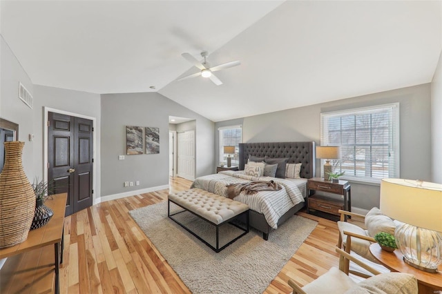 bedroom featuring lofted ceiling, baseboards, visible vents, and wood finished floors