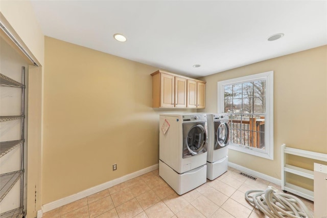 laundry room with cabinet space, independent washer and dryer, visible vents, and light tile patterned floors