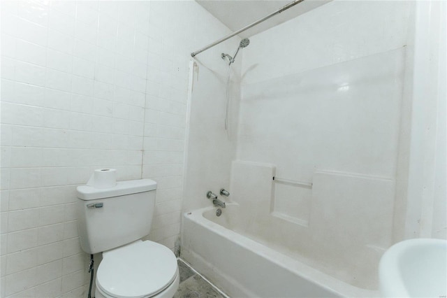 bathroom with toilet, tile walls, and tub / shower combination