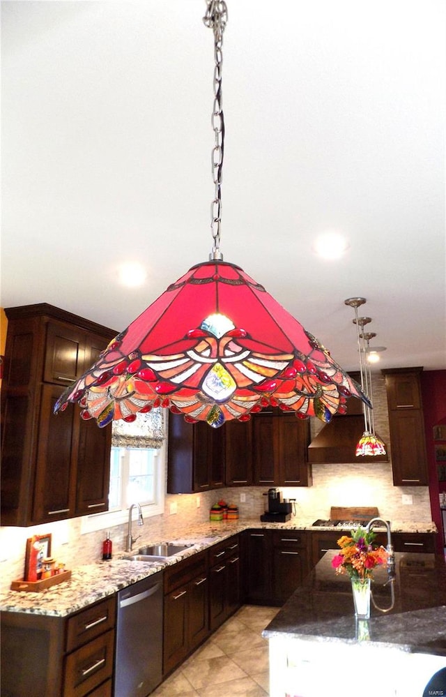 kitchen with dishwasher, dark brown cabinetry, sink, and pendant lighting