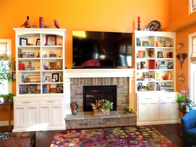 living room featuring a fireplace and dark hardwood / wood-style flooring