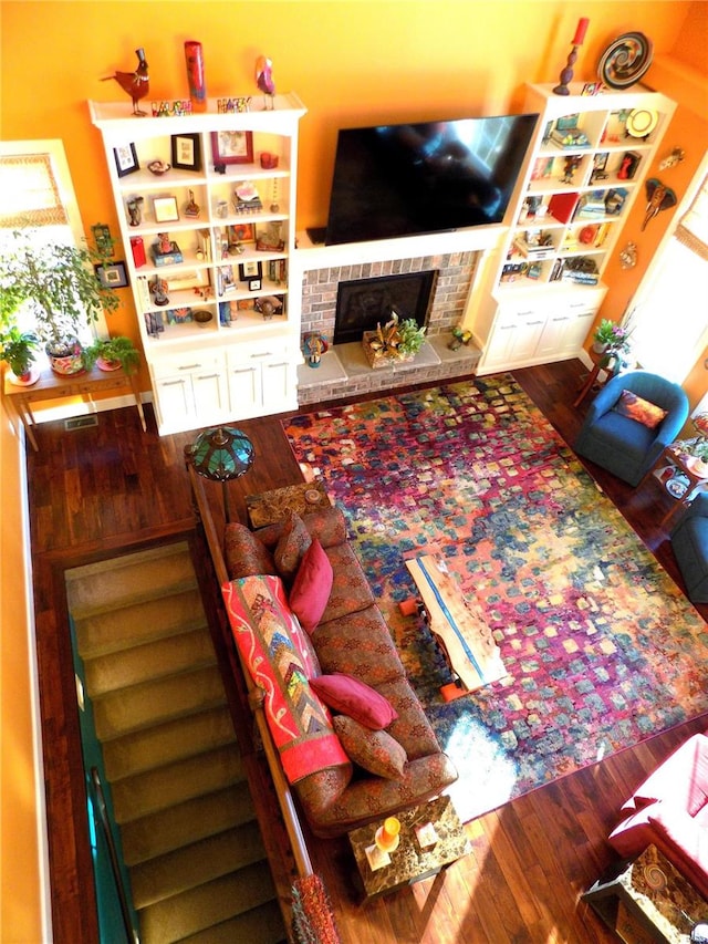 living room with a fireplace and hardwood / wood-style flooring