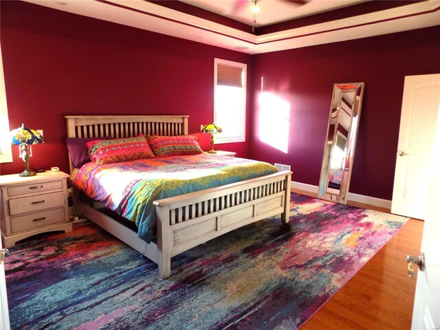 bedroom with ceiling fan and wood-type flooring