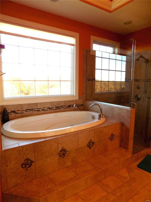 bathroom with shower with separate bathtub and tile patterned floors