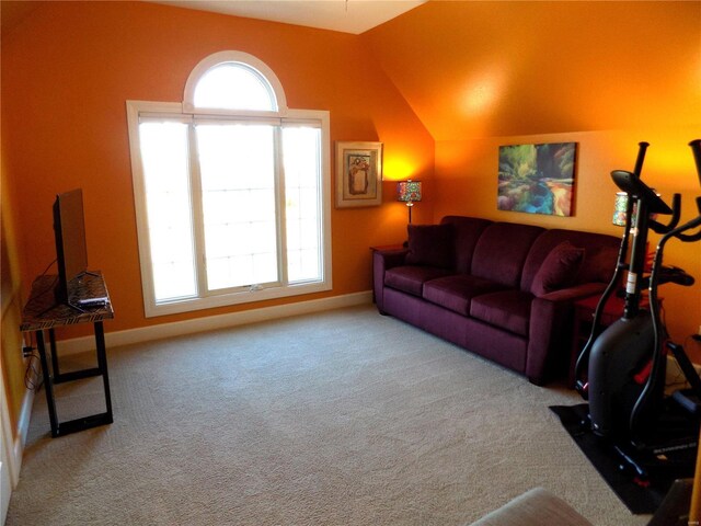 carpeted living room featuring plenty of natural light and vaulted ceiling