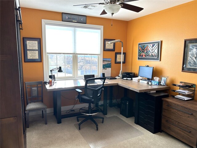 carpeted office featuring ceiling fan