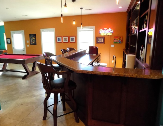 bar with pendant lighting, billiards, a wealth of natural light, and light tile patterned floors