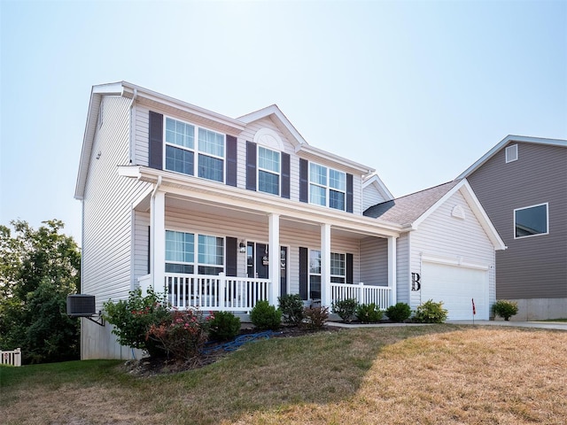 view of front of property with a garage, a porch, a front yard, and central AC unit