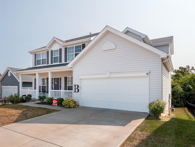 view of front facade with a garage, a porch, and a front yard