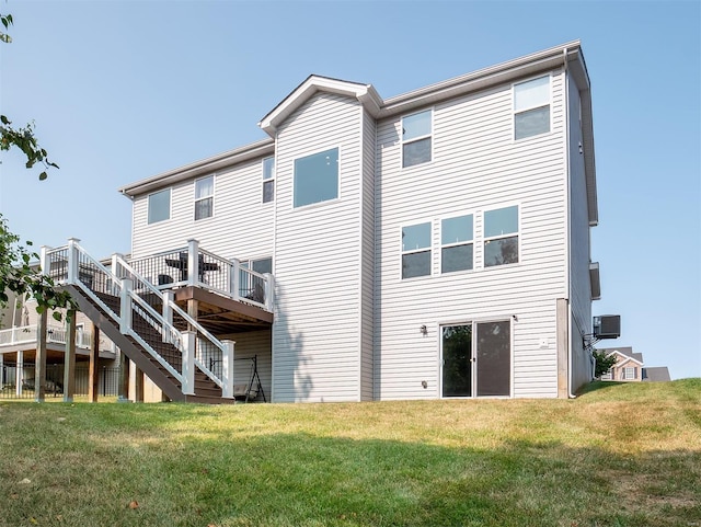 back of house with central AC unit, a lawn, and a wooden deck