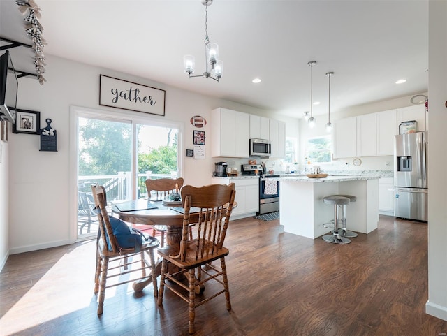 dining room featuring dark hardwood / wood-style flooring and a chandelier