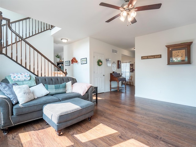 living room featuring dark wood-type flooring and ceiling fan