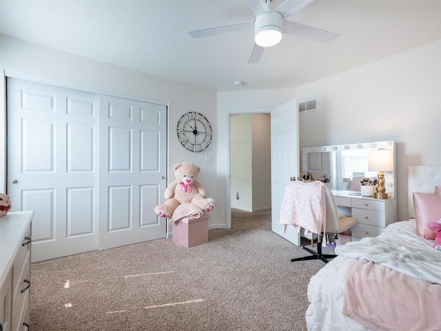 carpeted bedroom with ceiling fan and a closet