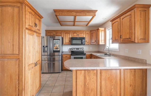 kitchen with kitchen peninsula, sink, light tile patterned floors, and stainless steel appliances