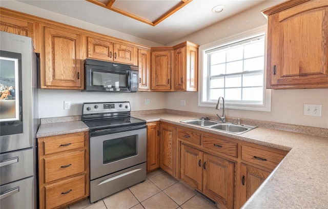 kitchen with light tile patterned flooring, sink, and appliances with stainless steel finishes