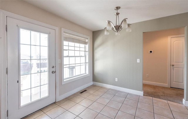 interior space featuring light tile patterned floors and a notable chandelier