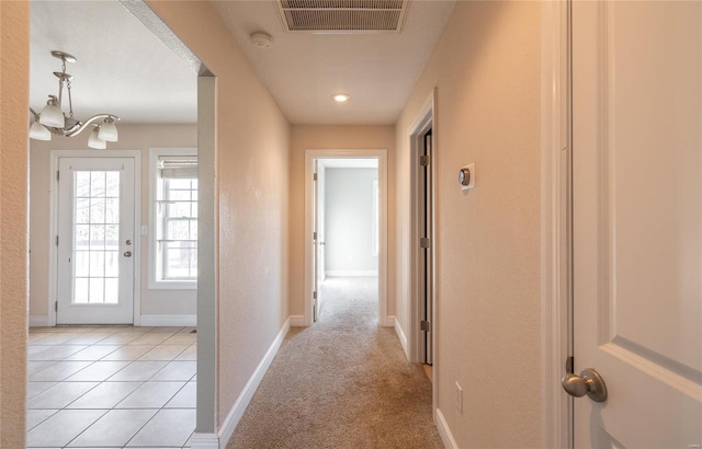 hall featuring light carpet