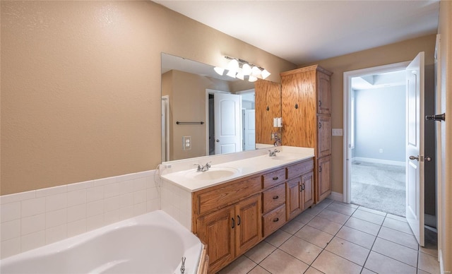 bathroom featuring tile patterned flooring, vanity, and a bathtub