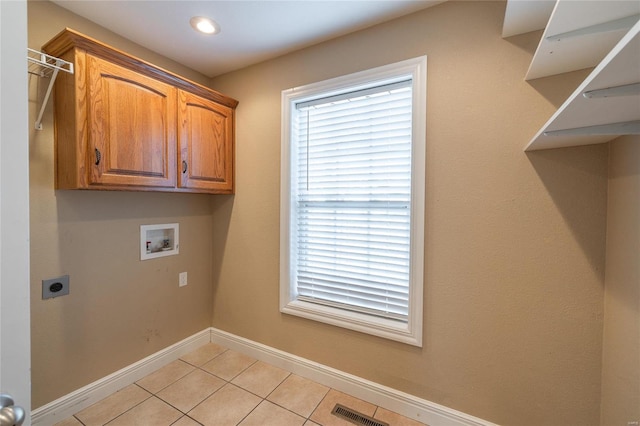 laundry room featuring hookup for an electric dryer, light tile patterned flooring, cabinets, and hookup for a washing machine