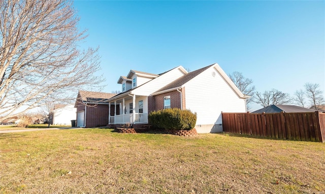 view of home's exterior with a lawn, a porch, and a garage