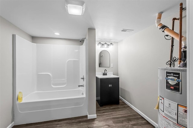 bathroom with shower / bathtub combination, water heater, vanity, and hardwood / wood-style flooring