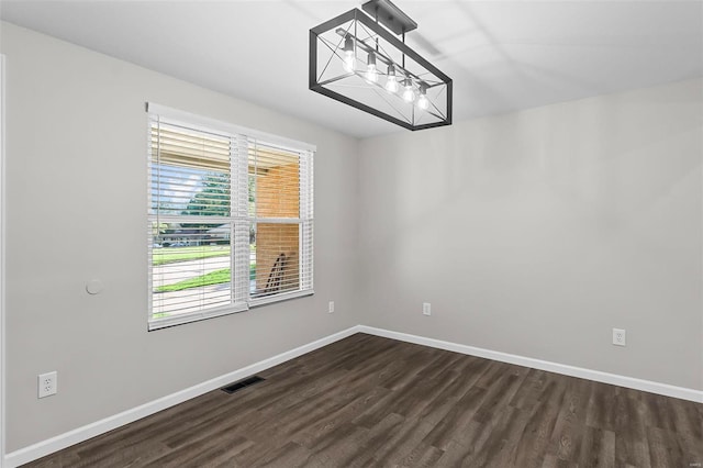 spare room with dark wood-type flooring