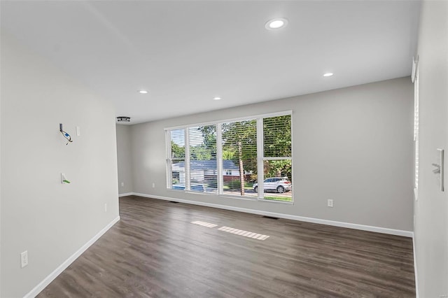 unfurnished room featuring dark hardwood / wood-style floors