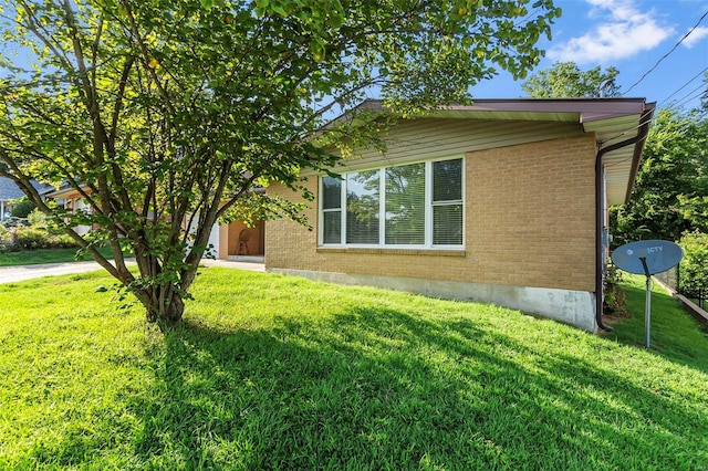 view of property exterior with a yard