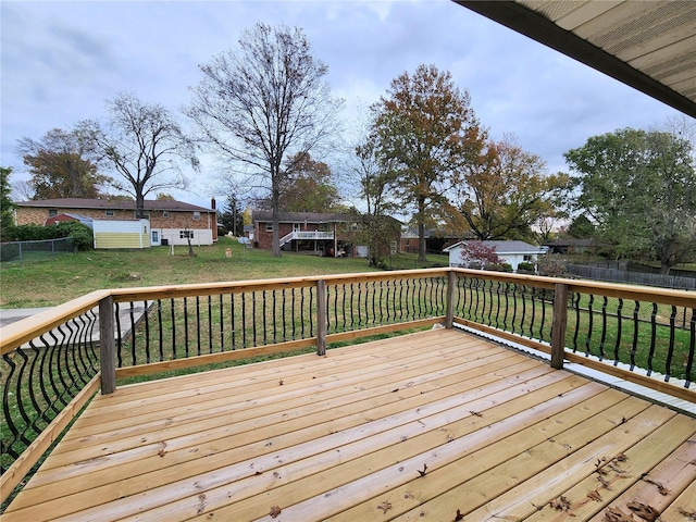 wooden deck with a lawn