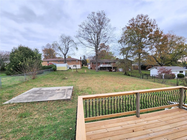 wooden deck featuring a lawn