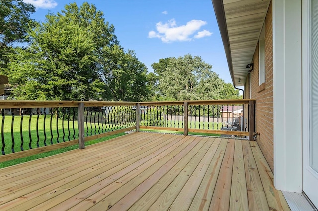 wooden deck featuring a yard