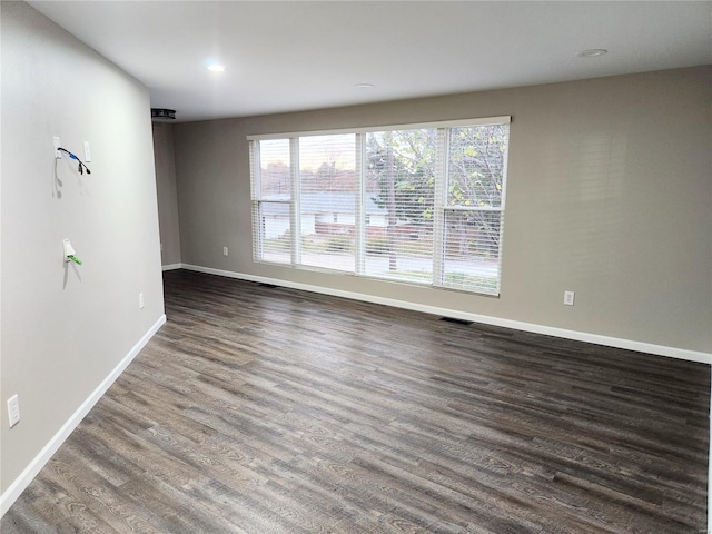 empty room featuring dark hardwood / wood-style flooring