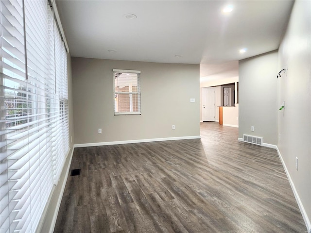 spare room with dark wood-type flooring