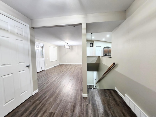 interior space featuring dark hardwood / wood-style floors and lofted ceiling