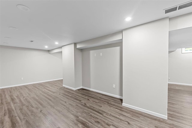 basement with hardwood / wood-style floors