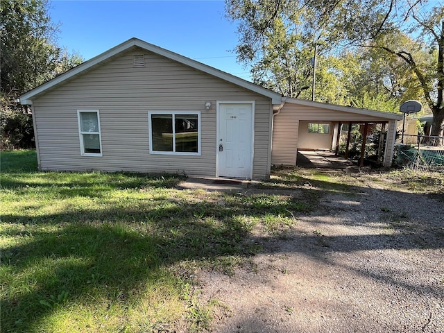 rear view of property with a yard