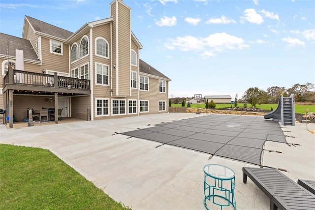 view of pool with a patio and a deck