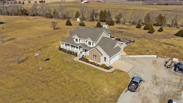 birds eye view of property with a rural view