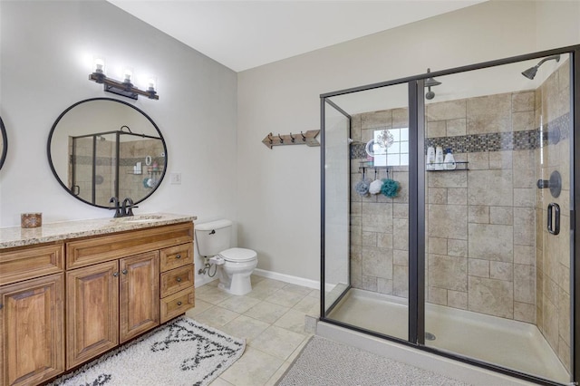 bathroom featuring a stall shower, baseboards, toilet, tile patterned floors, and vanity