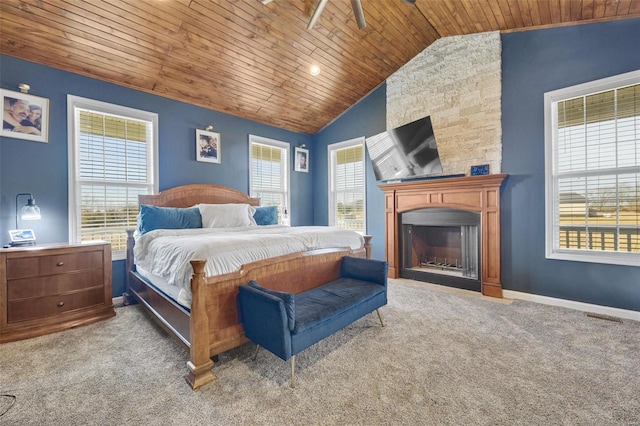 bedroom featuring lofted ceiling, wooden ceiling, light colored carpet, a fireplace, and baseboards