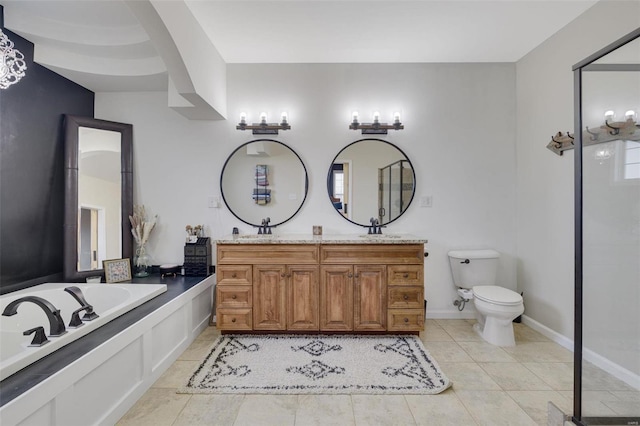 bathroom featuring double vanity, a sink, toilet, and tile patterned floors