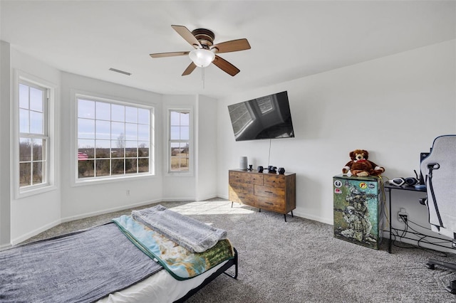 bedroom with ceiling fan, baseboards, and carpet flooring