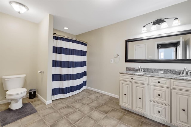 full bathroom featuring baseboards, a sink, toilet, and double vanity